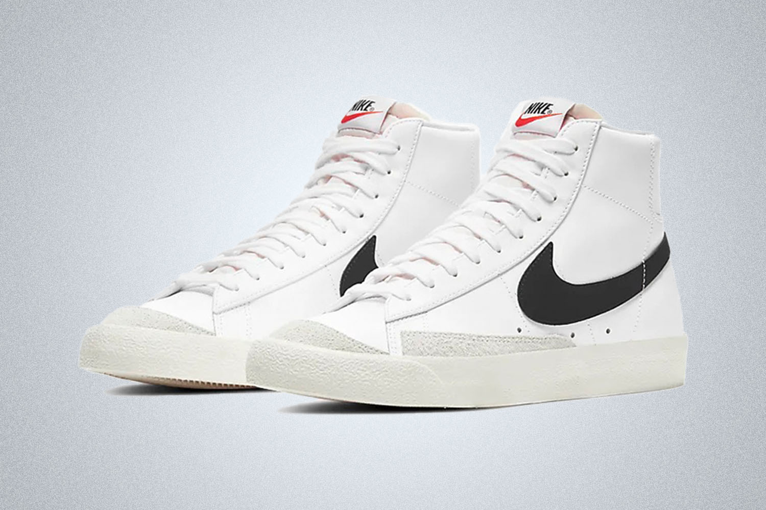 a pair of white and black accented Nike Blazer Mid '77 Tennis Shoes 