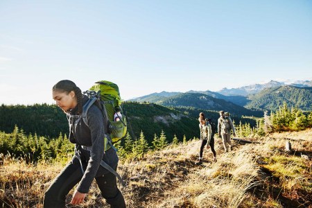 Three people hiking.