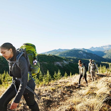 Three people hiking.