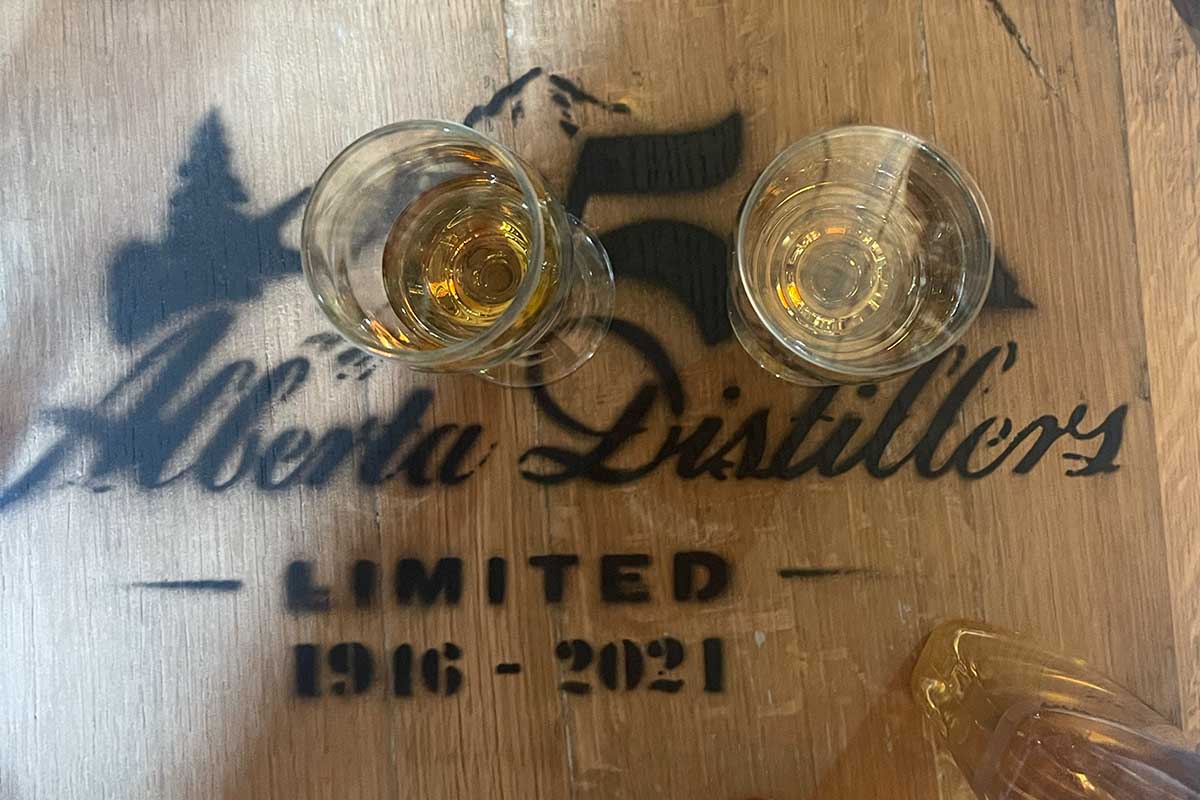 A close-up of tasting glasses on an Alberta Distillers barrel