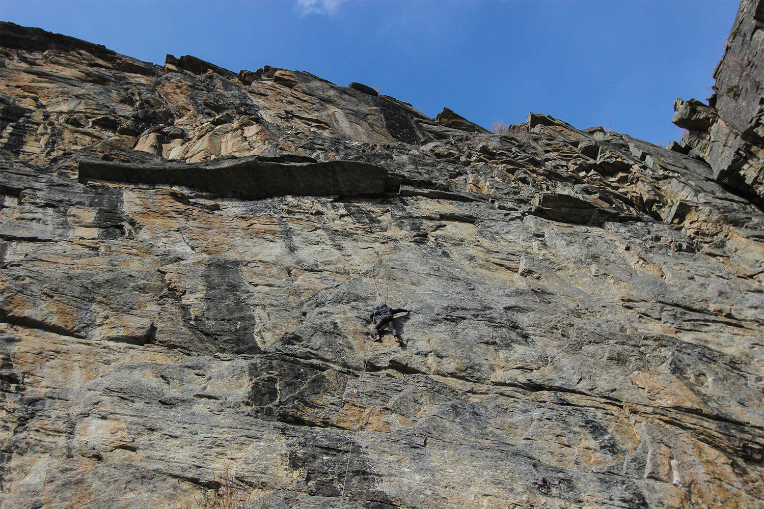 Writer and adventurer Joe Kanzangu rock rclimbing somewhere in Montana