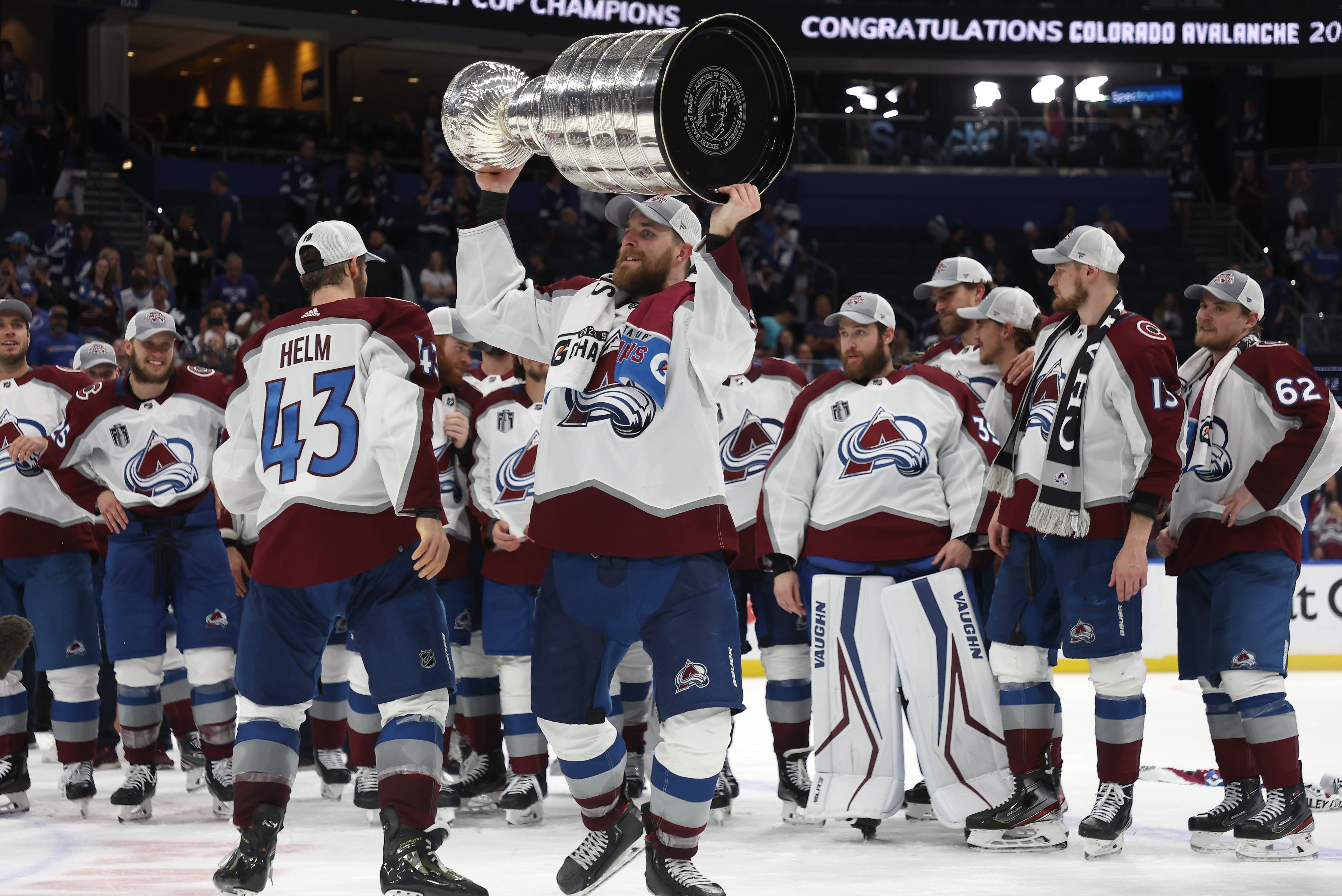 Darcy Kuemper of the Colorado Avalanche lifts the Stanley Cup after defeating the Lightning. The team dented the Cup just minutes after winning.