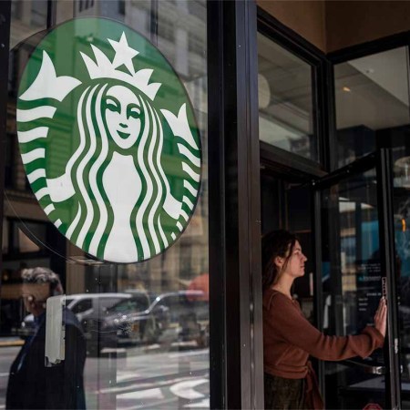 A customer exits a Starbucks coffee shop in San Francisco, California, U.S., on Thursday, April 28, 2022