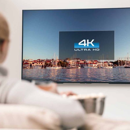 A woman watching 4K TV. New CGI-heavy movies may look bad on 4K TVs.