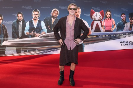 Brad Pitt at a premiere for Bullet Train in a man skirt, mauve button-up and loose blazer