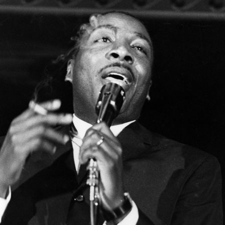 Comedian Dick Gregory performs onstage in circa 1961.