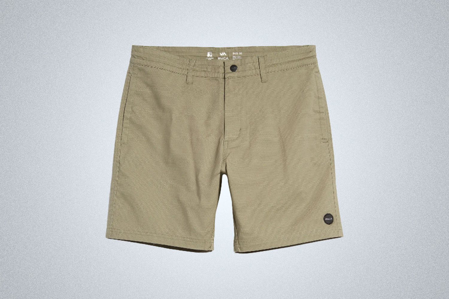 a pair of biege hybrid swim trunks from RVCA on a grey background