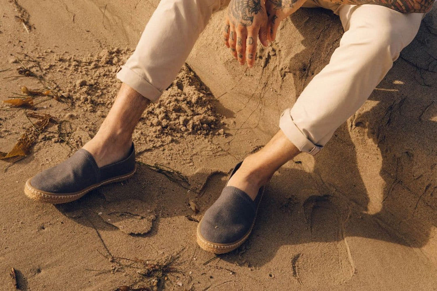 a model wearing a pair of Seeveas Espadrilles on the beach