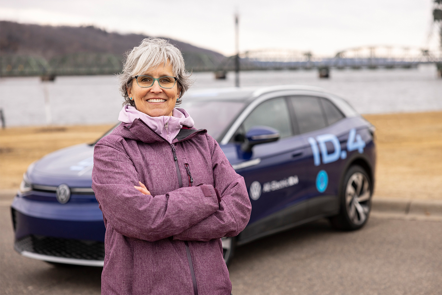 Erika Gilsdorf, the video producer of "What Fuels You," stands in front of a Volkswagen ID.4 electric SUV