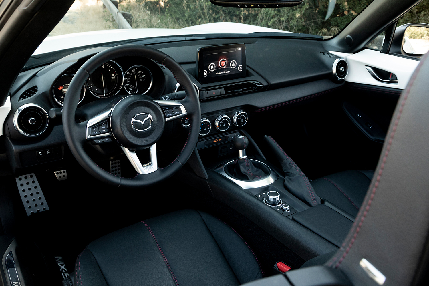 Interior of the Mazda MX-5 Miata with a six-speed stick shift in the center