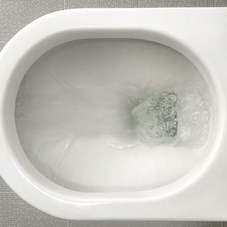 Water flushing down a toilet bowl