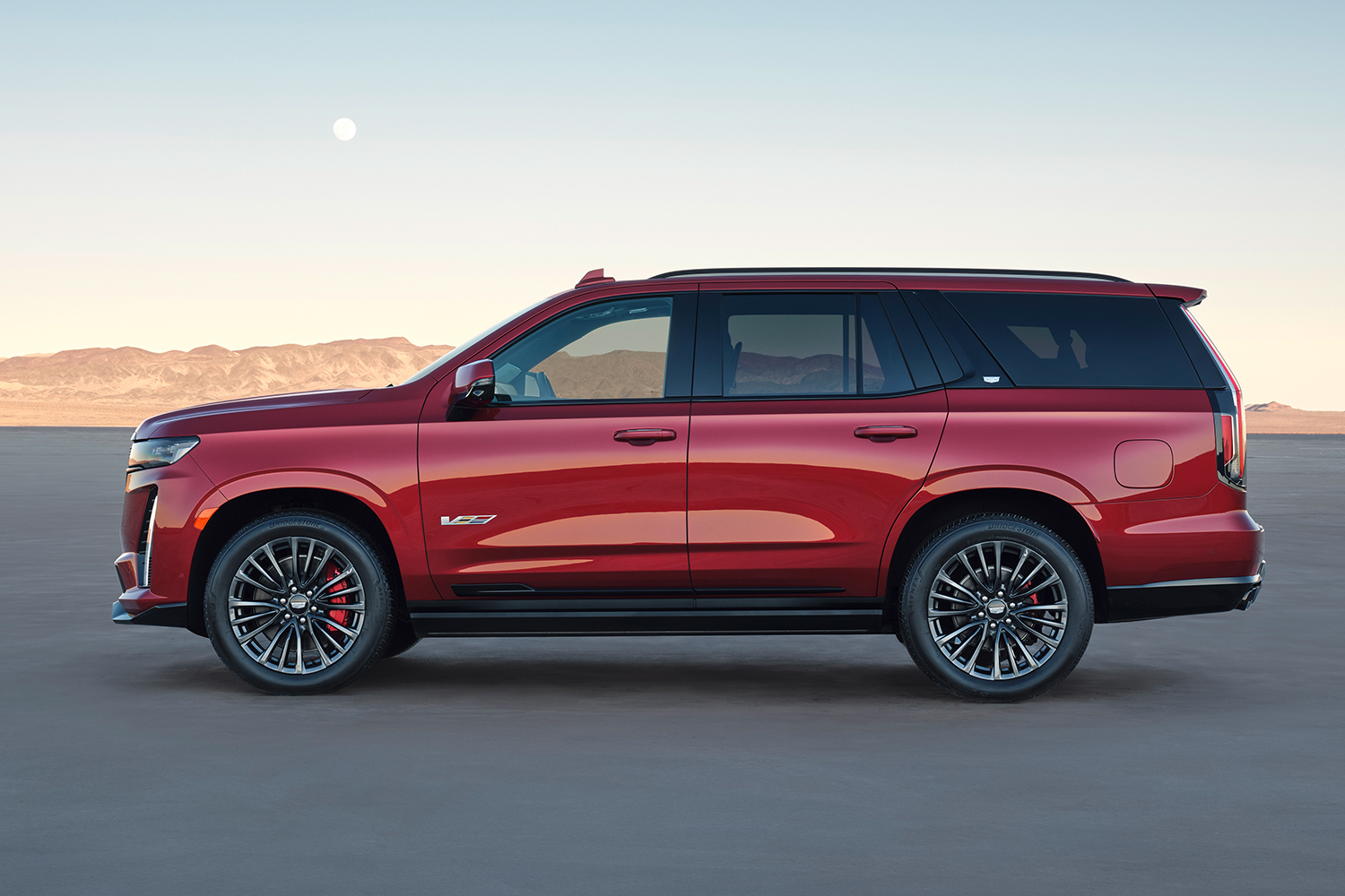 A side profile of the 2023 Cadillac Escalade-V SUV in red