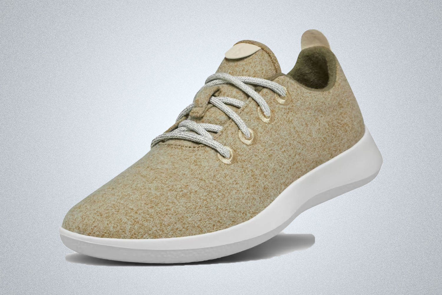 The khaki wool runner sneaker from Allbirds on a grey background