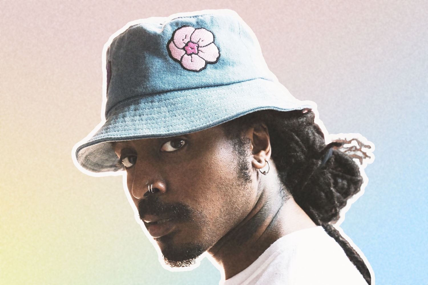 man in bucket hat on pastel background