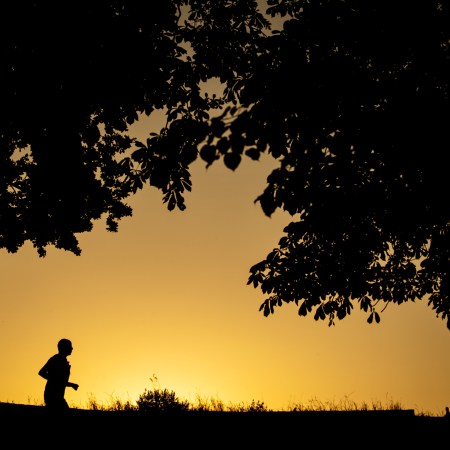 A jogger in front of sunrise.