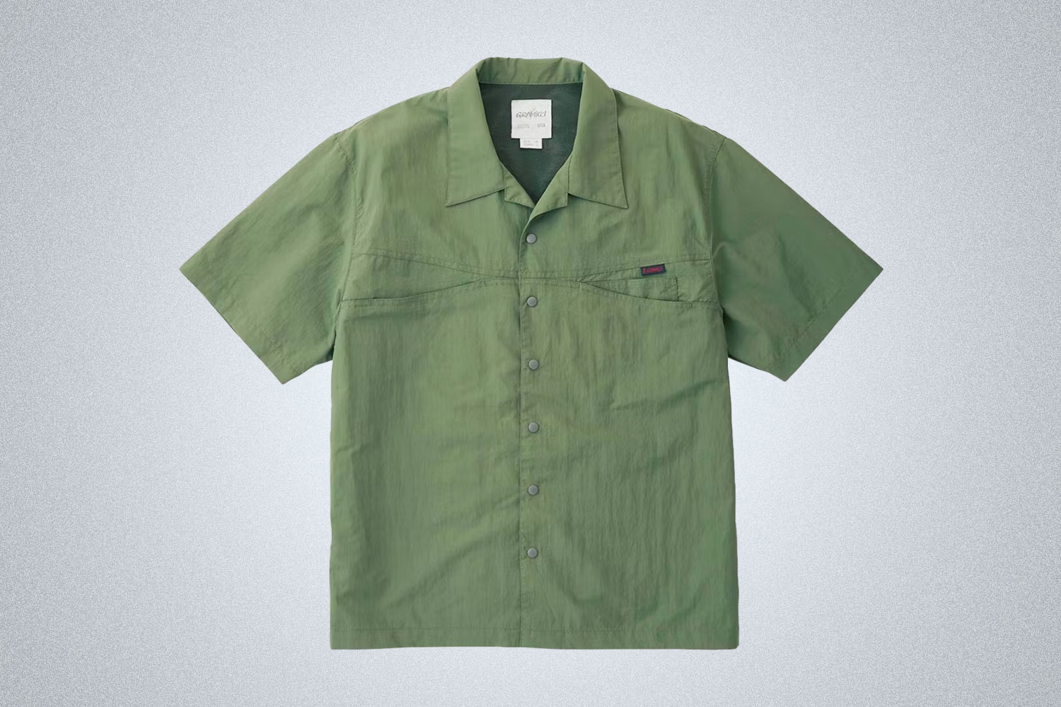 a green camp shirt from Gramicci on a grey background