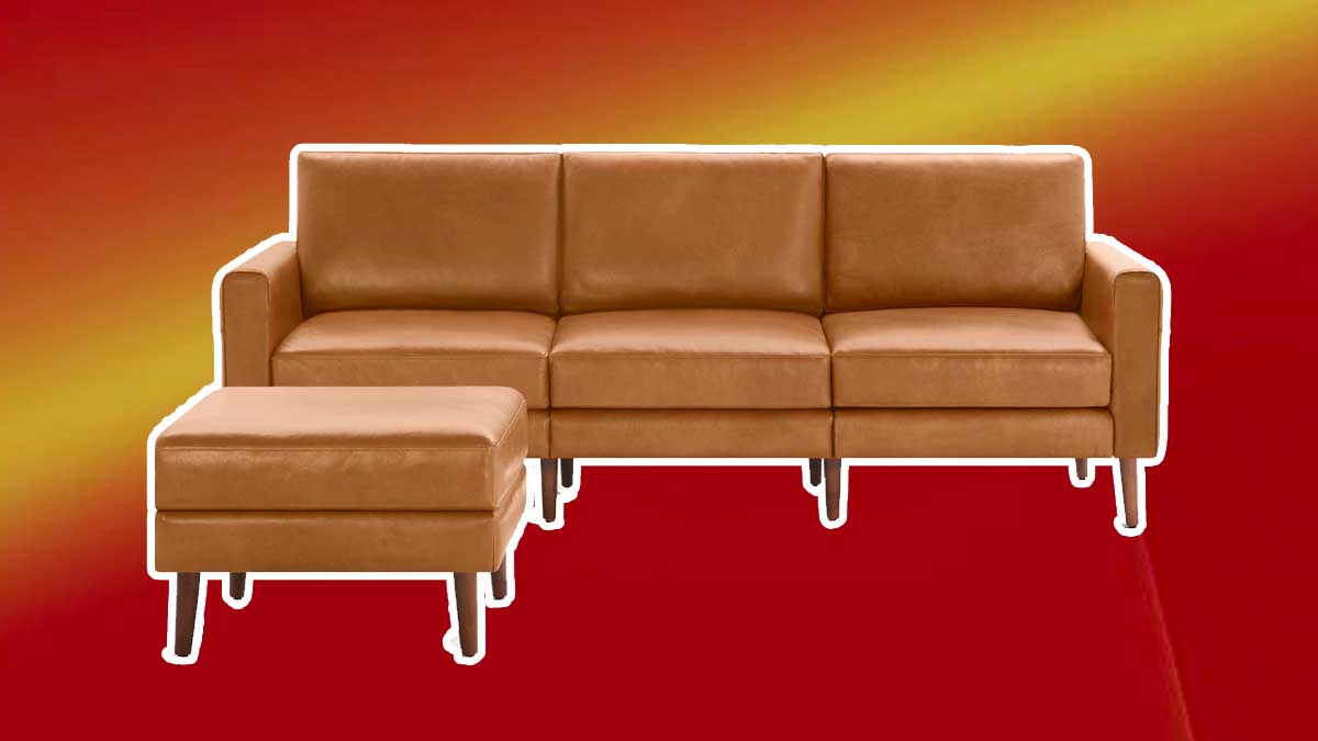 Burrow's leather Nomad sofa and ottoman on a red background