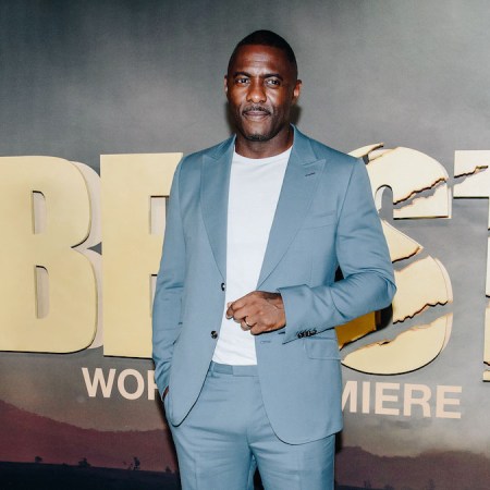 A photograph of actor Idris Elba at the Premier of "Beast" in a light chambray bule suit and white tee shirt