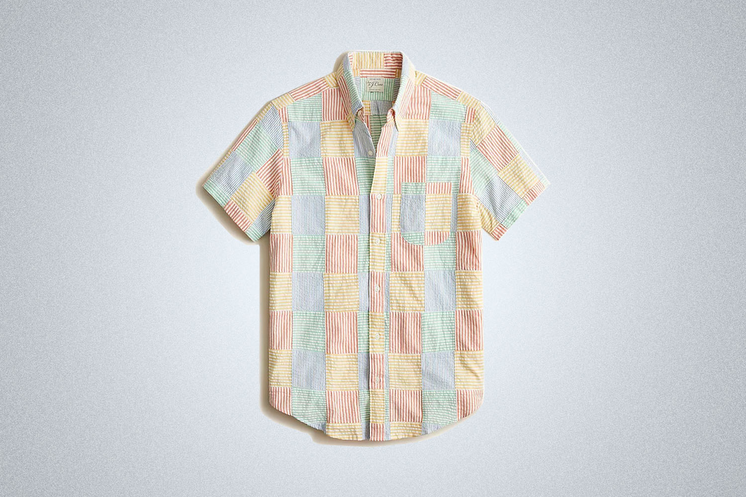 a patchwork seersucker shirt from J.Crew on a grey background