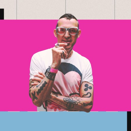 Industrial designer Karim Rashid, with his big trademark glasses, set in a pink, blue, black and grey background