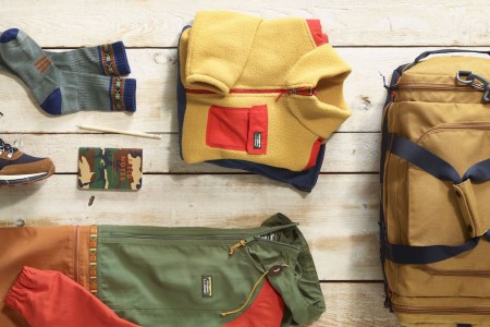 A lifestyle image of the L.L. Bean Mountain Classics Collection layed out on a wooden deck