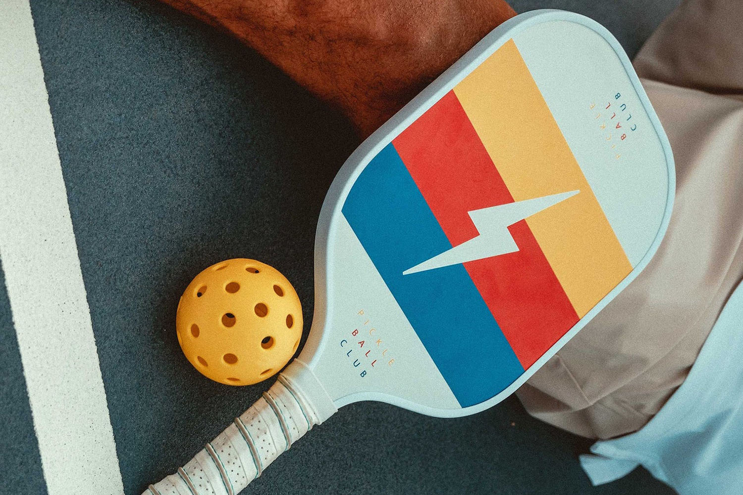 a mutli-colored pickleball paddle