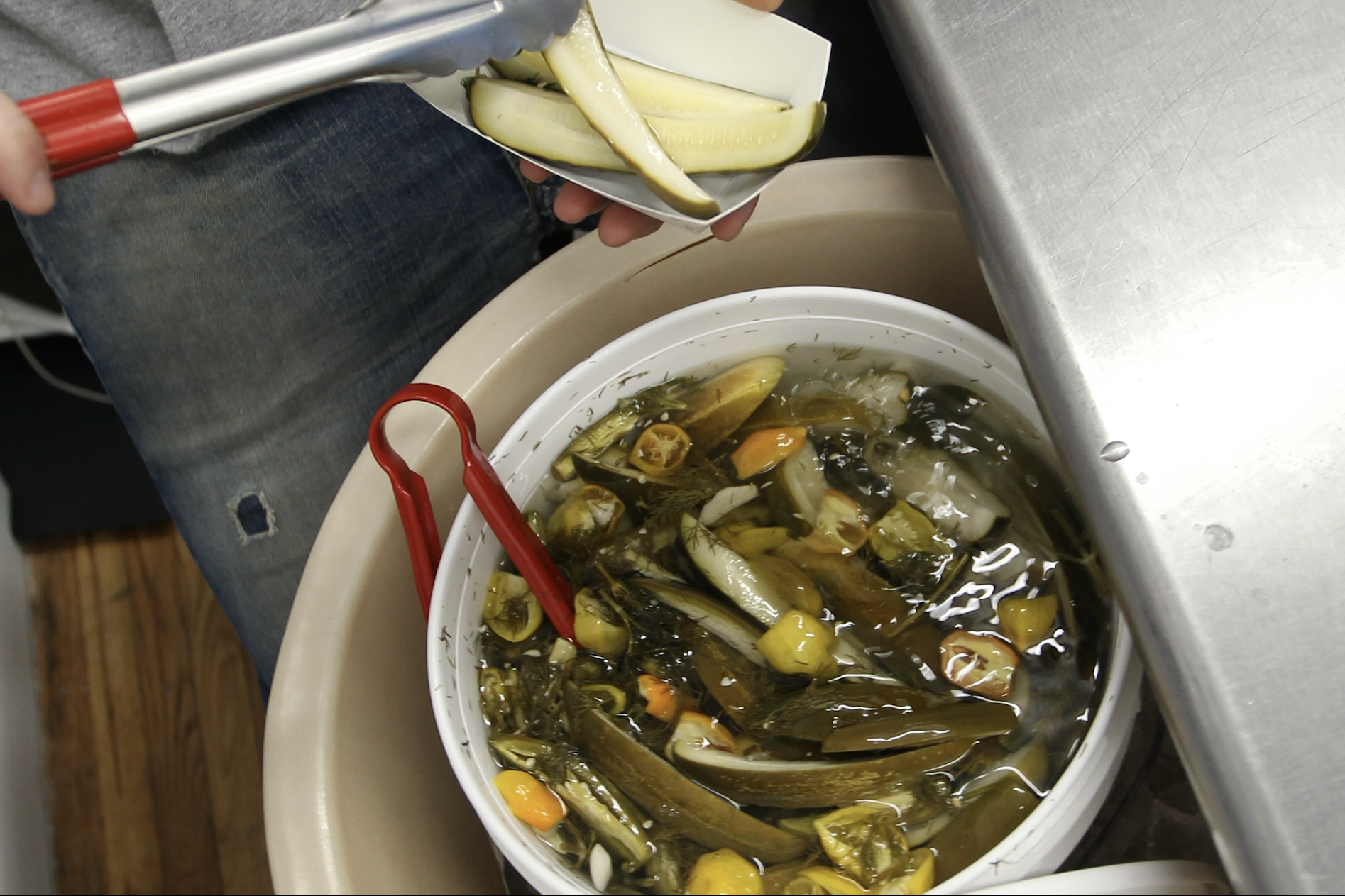 Grillo's Pickles owner Travis Grillo serves up pickles in Cambridge