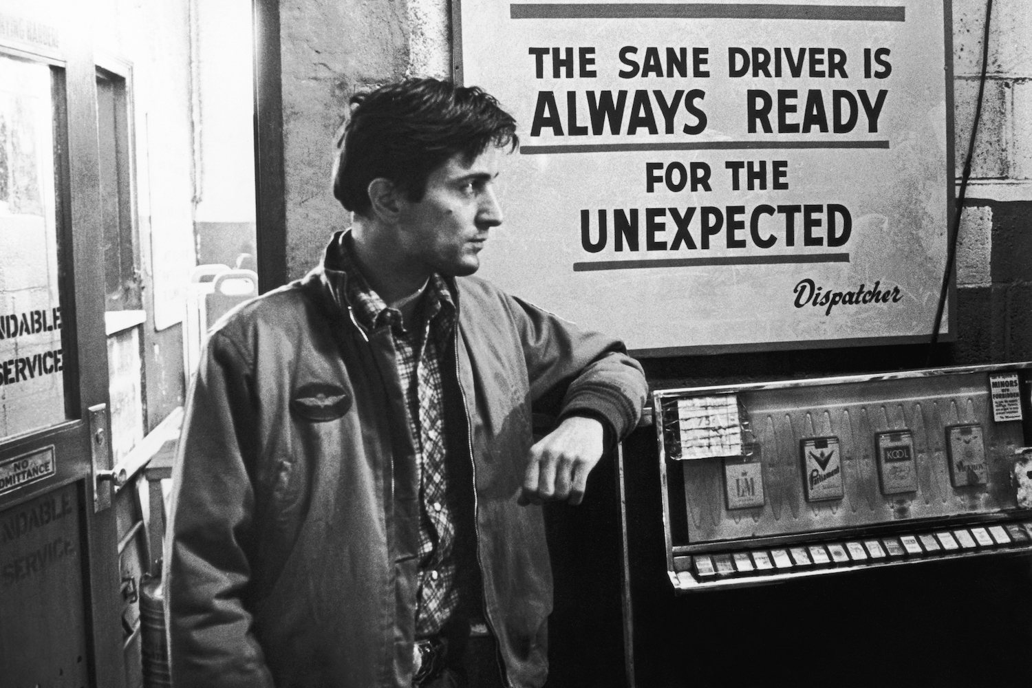 a black and white photograph of a young Robert De Niro from the movie "Taxi Driver"