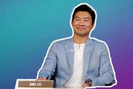 Simu Lui in a chambray blue Bonobos suit on a white and purple gradient background