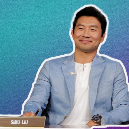 Simu Lui in a chambray blue Bonobos suit on a white and purple gradient background