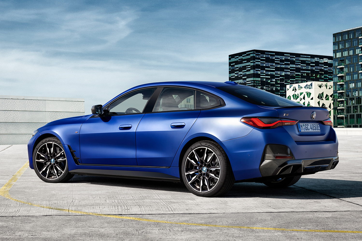 The rear of the 2022 BMW i4 M50 electric sedan in blue