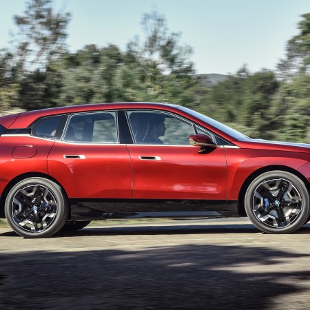 The BMW iX xDrive50 electric SUV in red