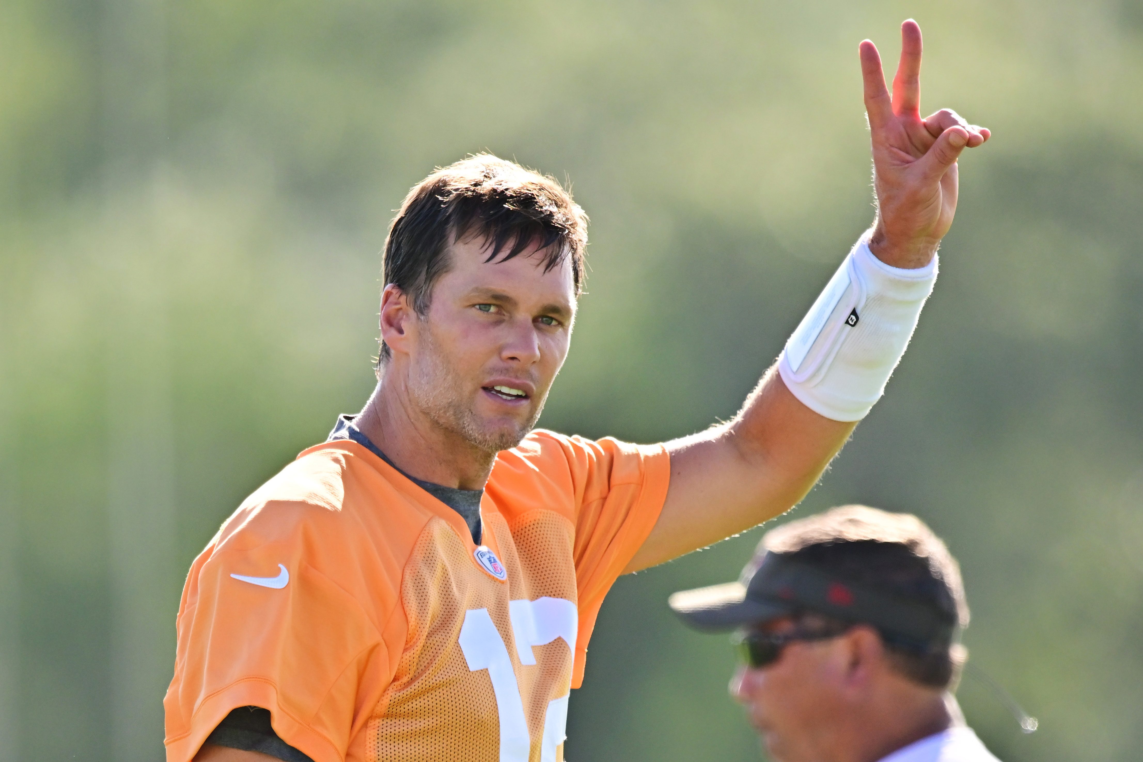 Tom Brady of the Tampa Bay Buccaneers gestures to fans at training camp.