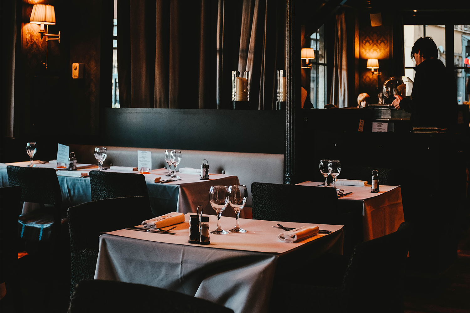 An empty restaurant with tables set for dinner