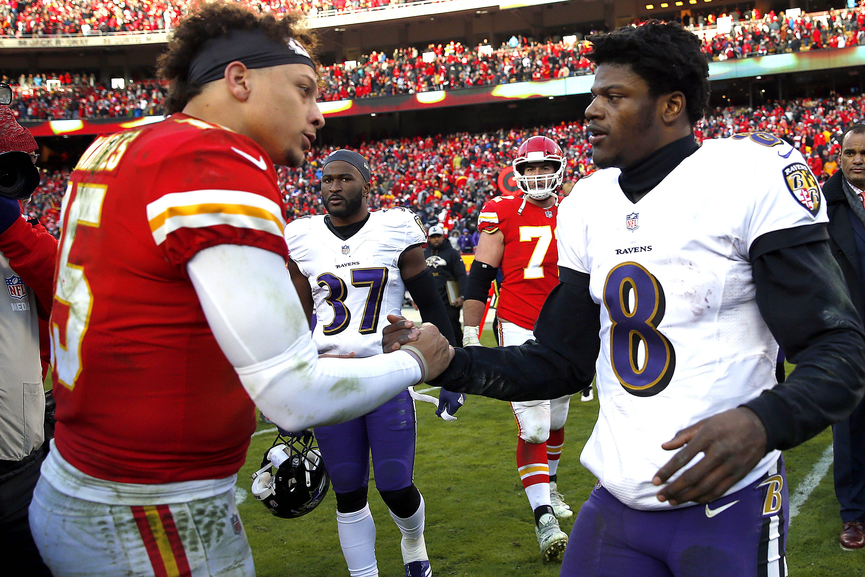 Black quarterbacks Patrick Mahomes and Lamar Jackson greet each other after a 2018 game