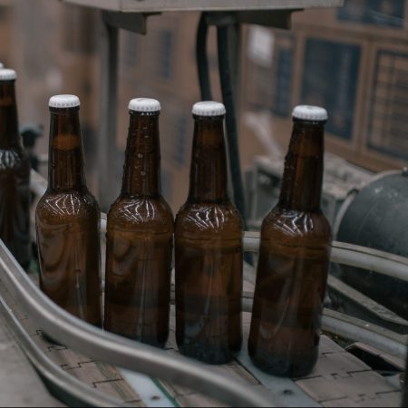 Bottles of beer move along a conveyor at the Cerveza Minerva facility in Mexico.