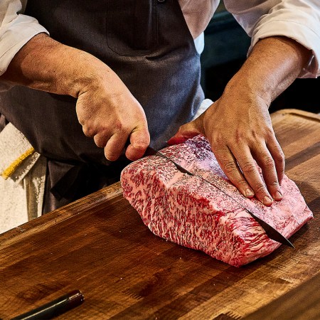 Chef Dustin Falcon of Niku Steakhouse in San Francisco slices through wagyu steak