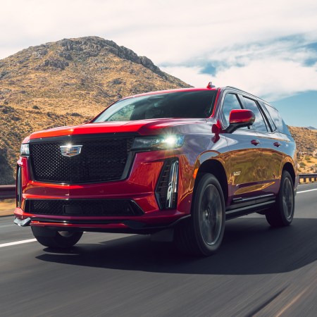 The 2023 Cadillac Escalade-V, which our automotive editor reviewed, driving down the road