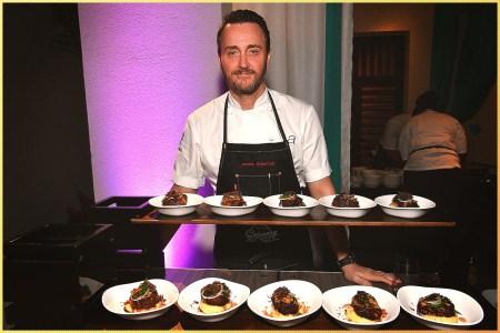 Chef in front of plates of food