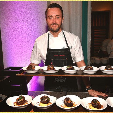 Chef in front of plates of food