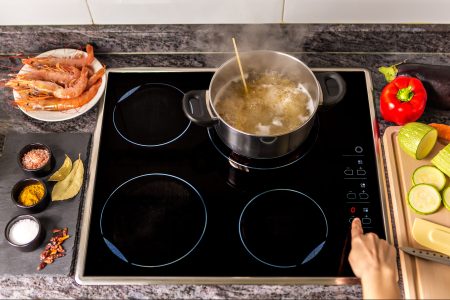 A pot of noodles cooking on an induction stovetop