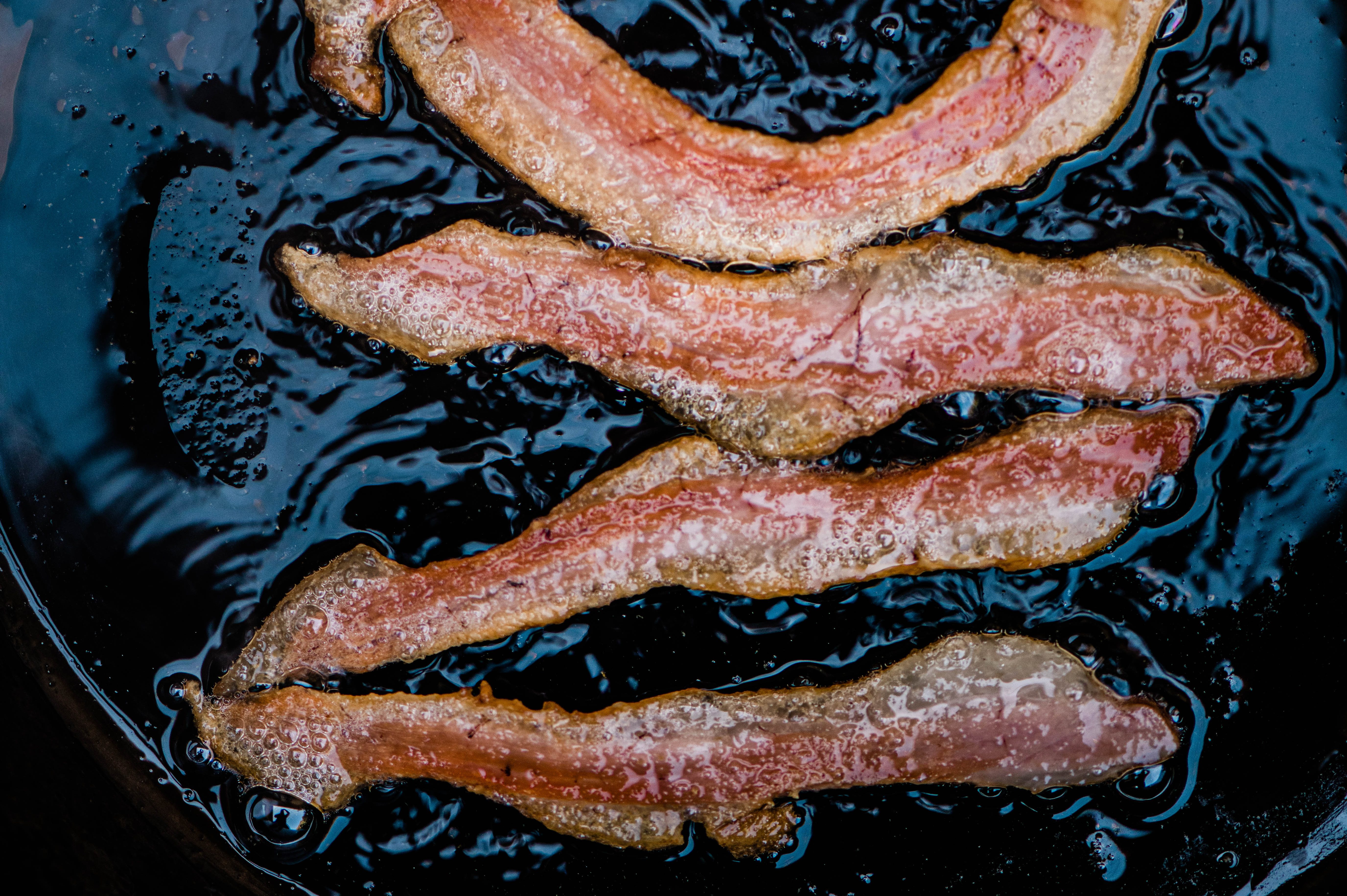 Crispy bacon slices served up in a skillet.