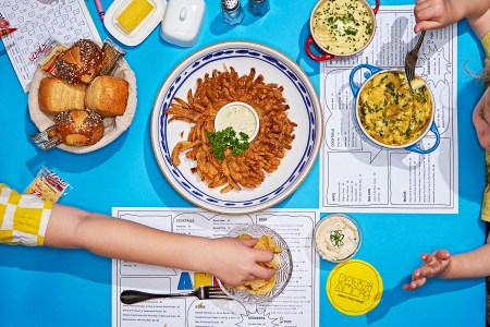 Lots of comfort food on a table including mashed potatoes and mac and cheese