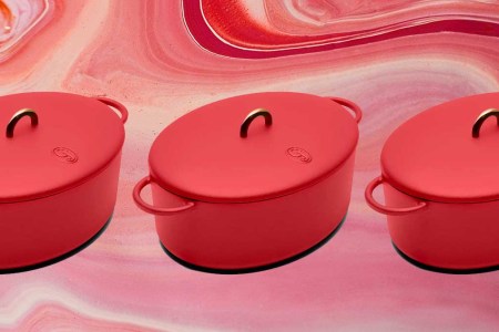 The Dutchess 6.75-Quart Enamel Cast Iron Dutch Oven with Lid on a red background