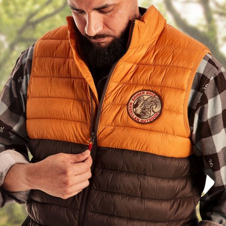 A man wearing a Shiner Beer vest from the new Shiner x Magellan Outdoors collection