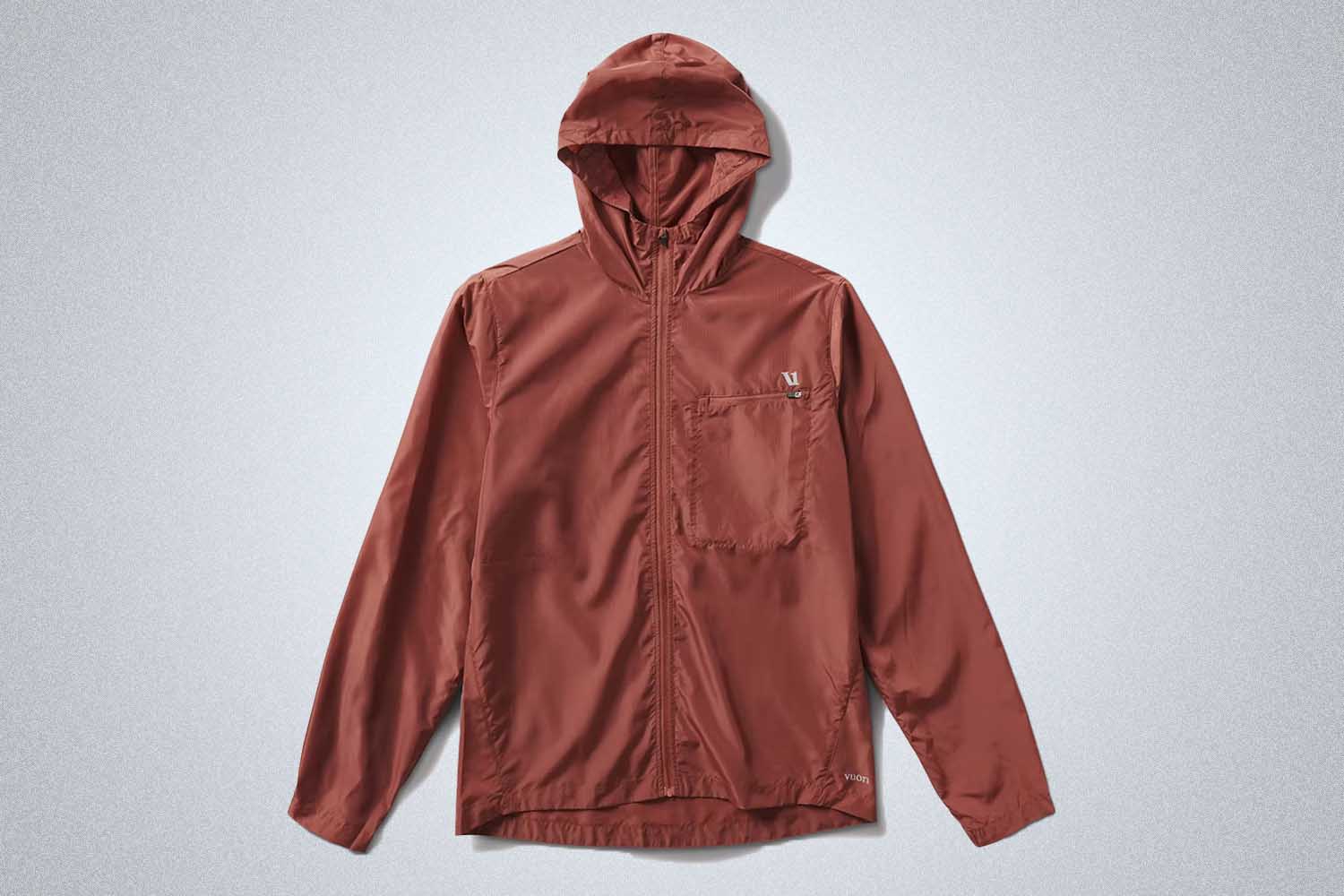 a red windbreaker from Vuori on a grey background