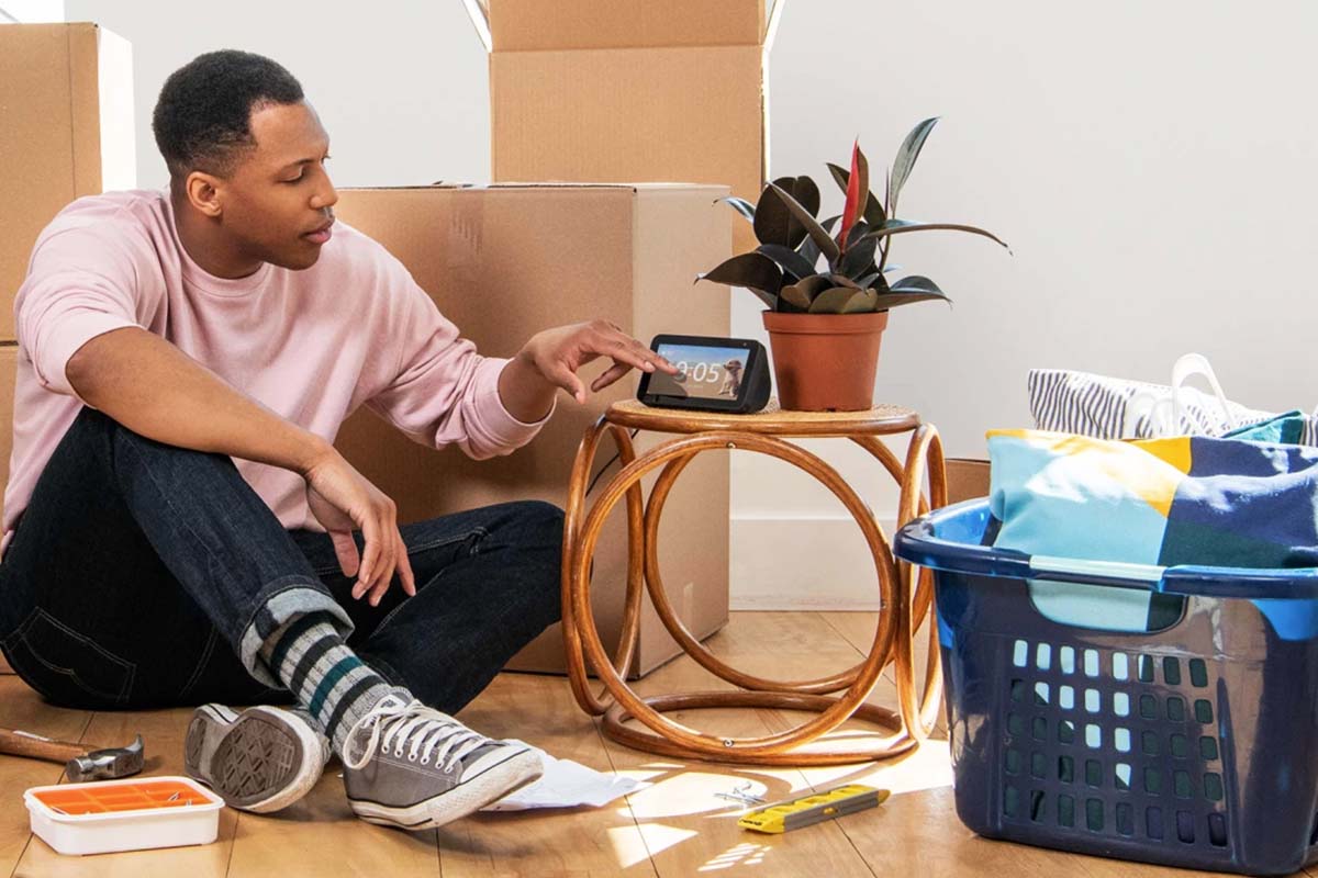 Man on floor asking an Amazon Echo device a question. Is this really just Amazon Alexa ads?