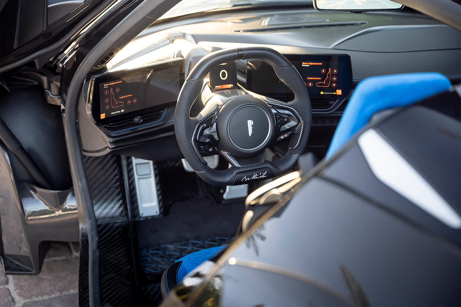 The cockpit of the Battista hypercar from Automobili Pininfarina, showing the signature of Battista "Pinin" Farina on the bottom