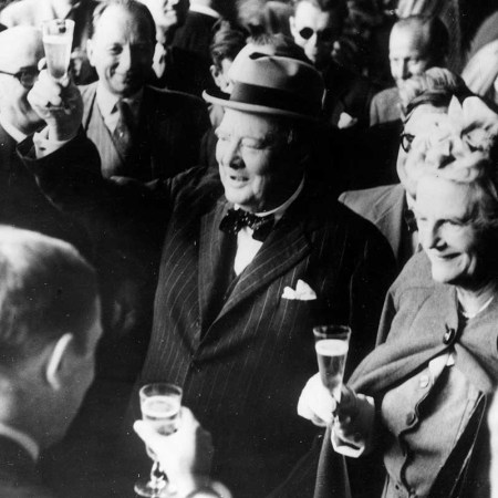 26th August 1946: Former British prime minister Winston Leonard Spencer Churchill (1874 - 1965) and his wife Clementine make a toast upon their arrival in Switzerland.