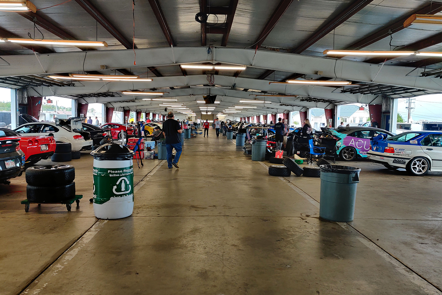 A gathering of the COM Sports Car Club with drivers and their cars at Watkins Glen